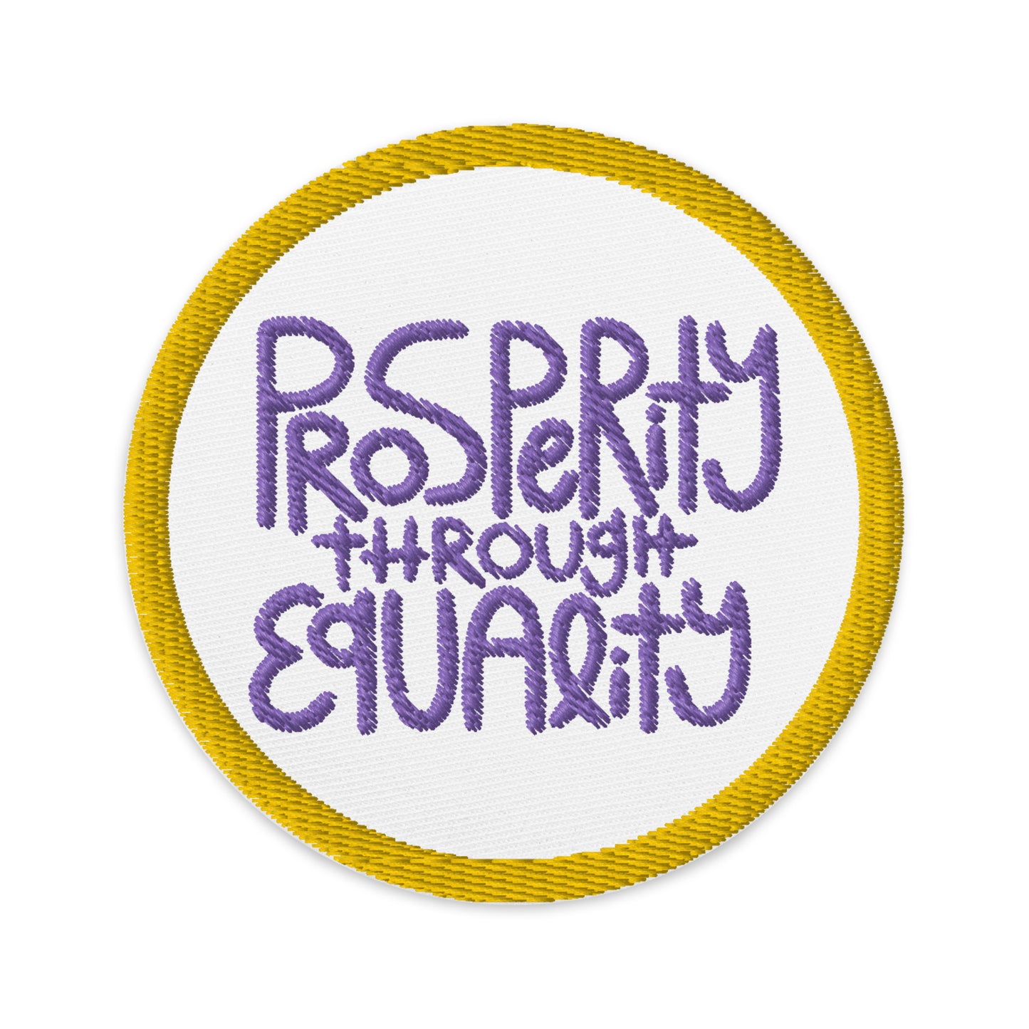 white, circular patch with an embroidered gold border. In the center of the patch with purple embroidery it read "Prosperity through equality."