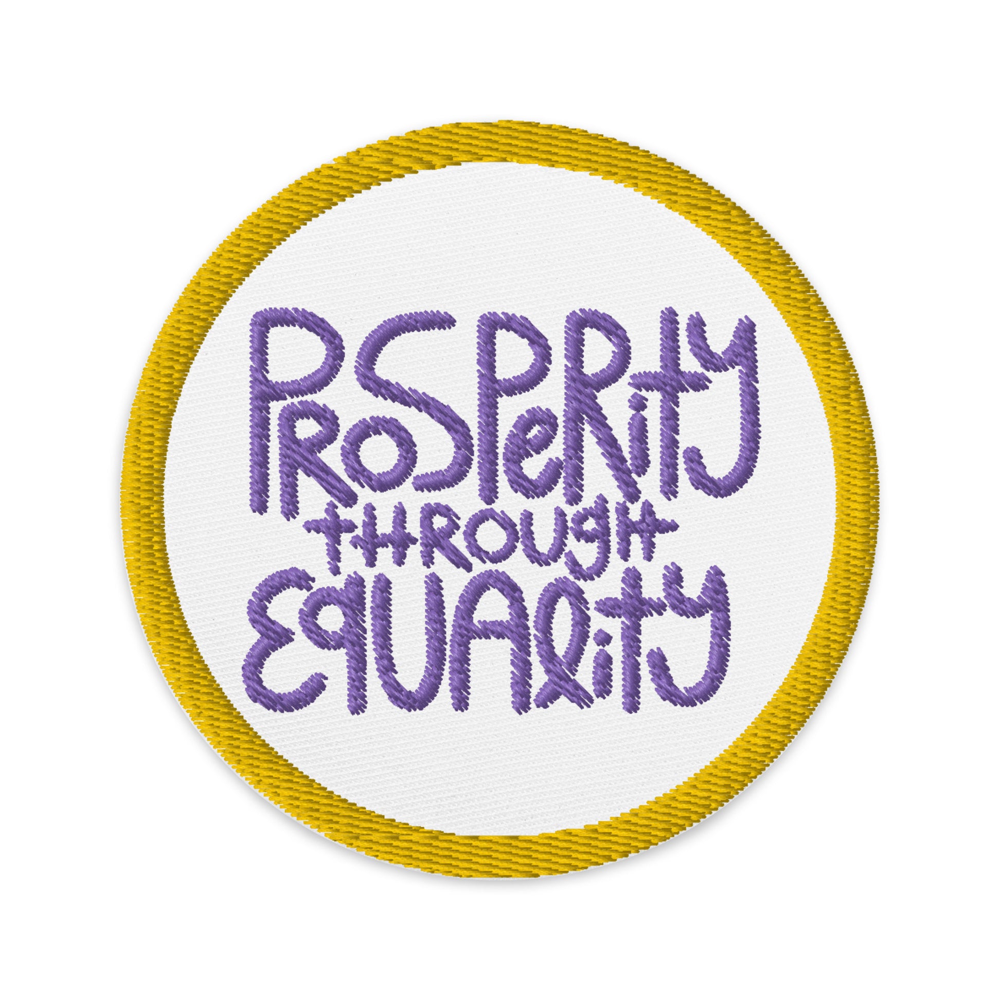 white, circular patch with an embroidered gold border. In the center of the patch with purple embroidery it read "Prosperity through equality."
