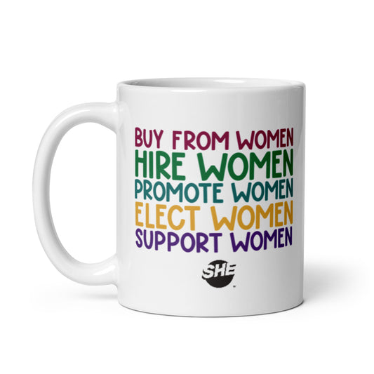 11 oz. white mug with "Buy from women" in ruby, followed by "Hire women" in green, "Promote women" in teal, "Elect women" in gold, and "Support women" in purple. The text is printed on the mug twice; once on each side so it's visible regardless of in which hand you hold the handle. Below the text is a black SHE Mark logo.